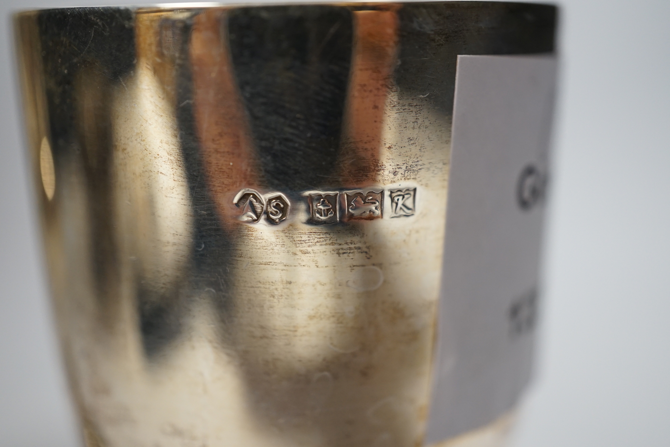 A small modern silver goblet, 11.2cm. and one other larger white metal goblet.